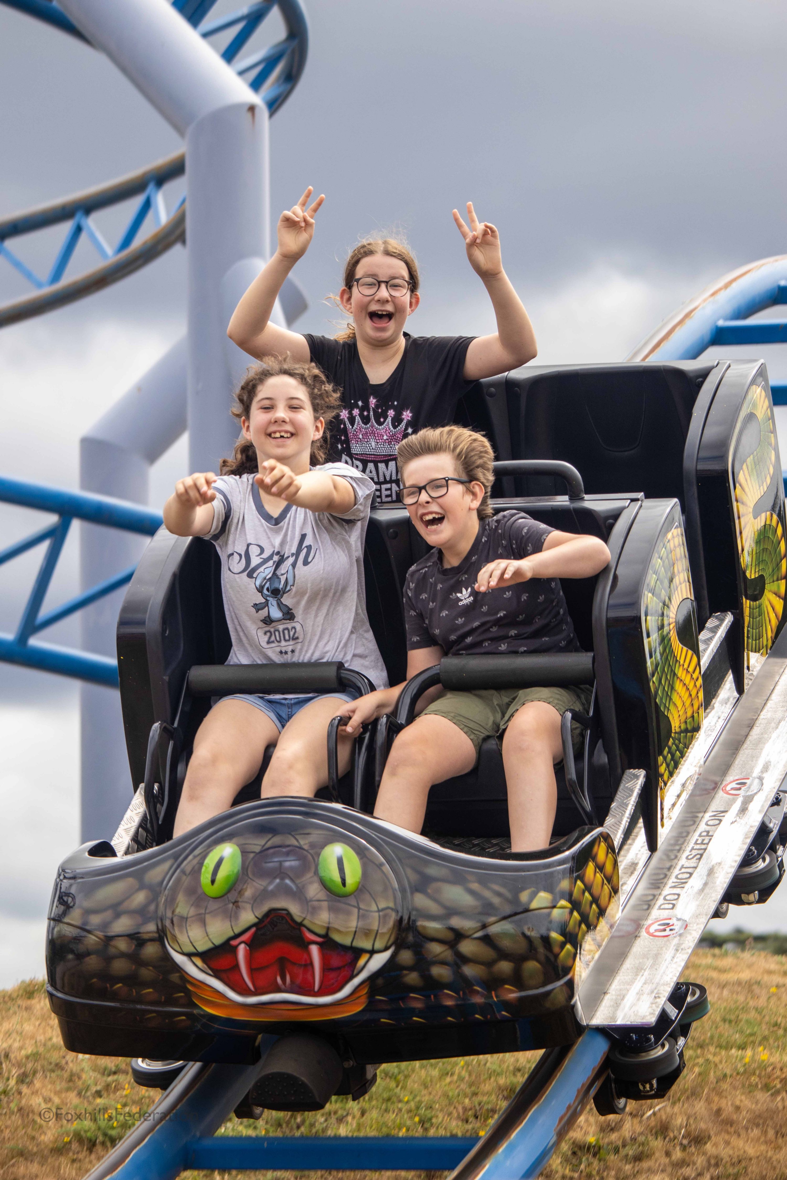 A group of children scream on a rollercoaster